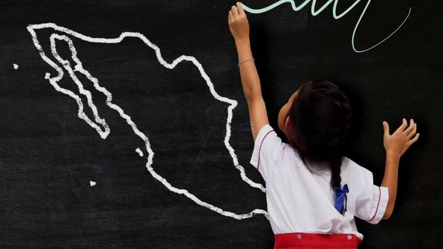 Girl drawing on blackboard